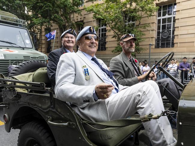 Frank Burns, Speedy Manfield and Jamie Stephenson make their way through the ANZAC Day parade through Brisbane city. Picture: Matthew Poon