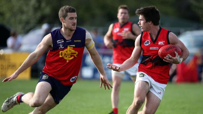 Matt Burkett of Romsey looks for a teammate. Picture: Mark Dadswell