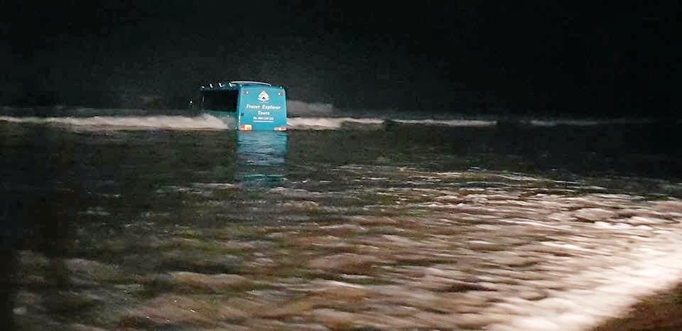 The Central Queensland Plane Spotting Blog has shared photos of a bus attempting to rescue the Air Fraser Island Airvan ahead of high tide. Picture: CQ Plane Spotting Blog