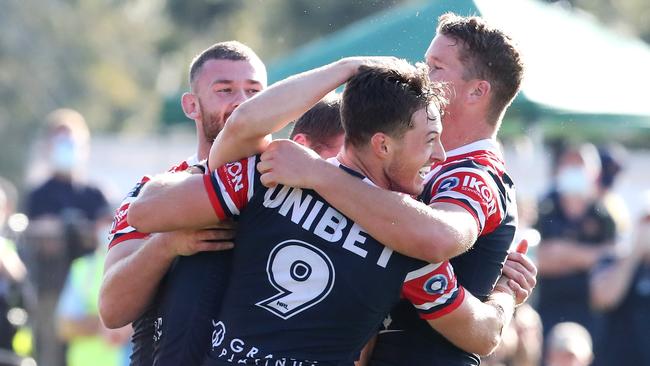 Drew Hutchison (unseen) of the Roosters celebrates a try (Photo by Jono Searle/Getty Images)