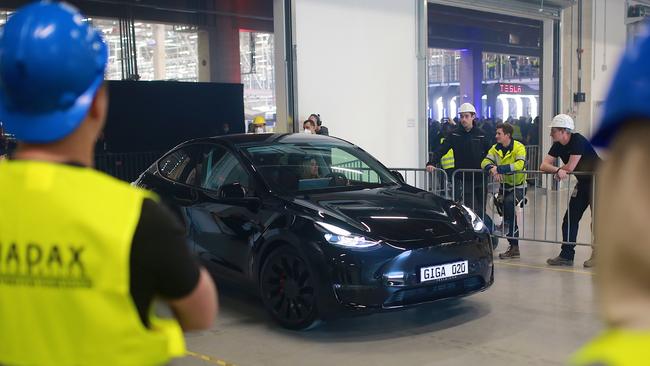 A new Tesla car leaves the factory during the official opening of the new Tesla electric car manufacturing plant near Gruenheide, Germany last month. The new plant, officially called the Gigafactory Berlin-Brandenburg, is producing the Model Y as well as electric car batteries. Picture: Getty Images