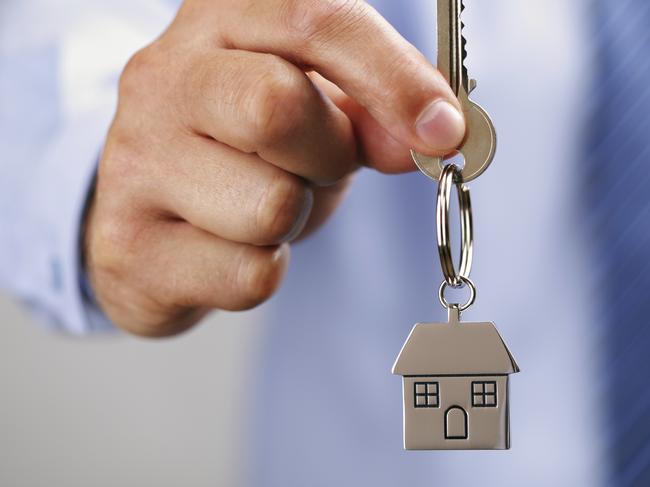 Holding out house keys on a house shaped keychain. Istock photo free to use.