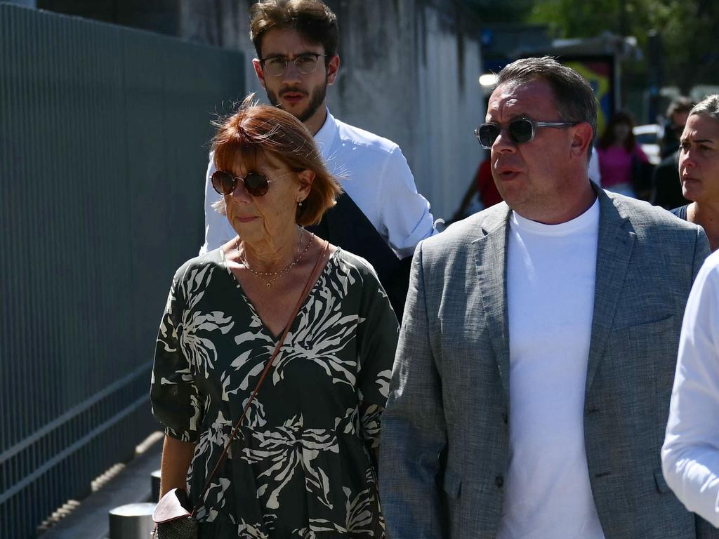 Gisele P. (left, with son David) has bravely waived her right to anonymity and appeared in court every day. Picture: Christophe Simon / AFP