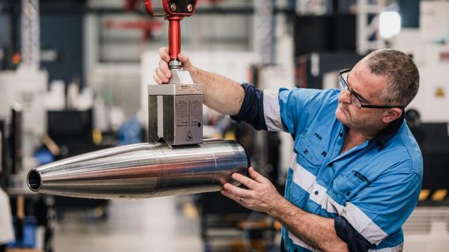 A Nioa worker examines a 155mm shell casing produced at the company’s Maryborough plant.