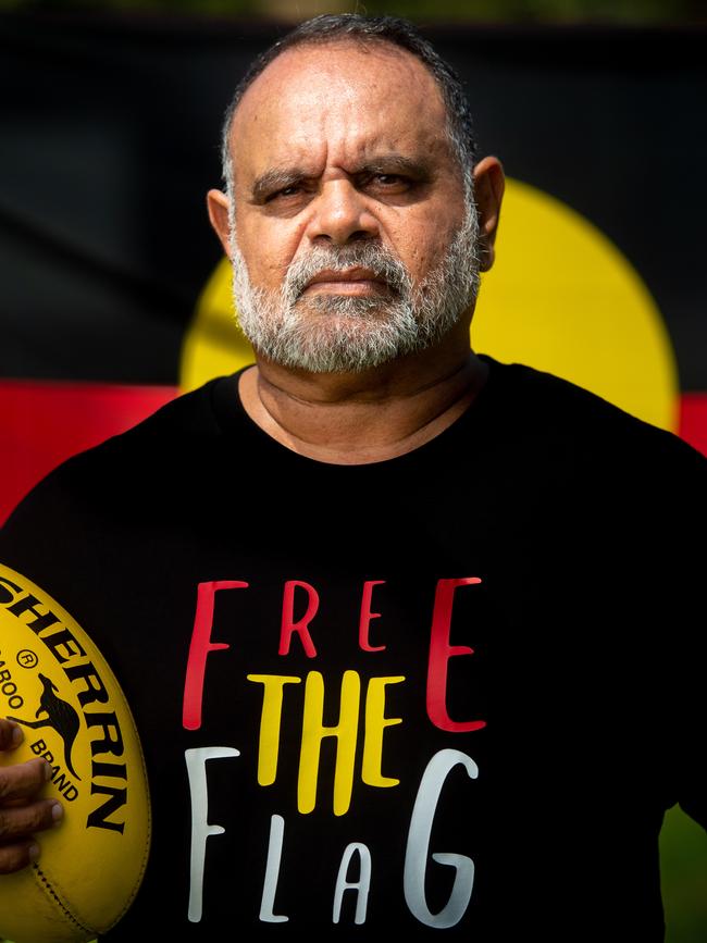 Michael Long stands with the Aboriginal Flag at Gardens Oval, Darwin. Picture : Che Chorley