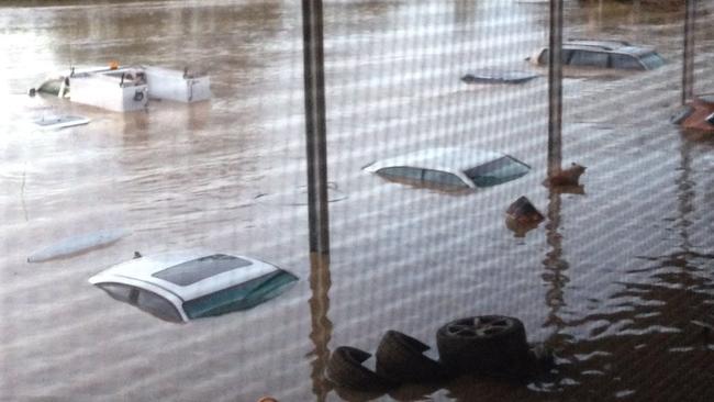 A house in Llandilo, next to South Creek has been completely inundated as cars are almost covered. Picture: Avineet Sen