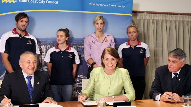 Watched by athletes, Queensland Premier Anna Bligh signed the 2018 Gold Coast Games bid with ACGA president Sam Coffa and Gold Coast mayor Ron Clarke.