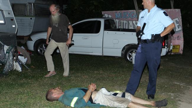 Police stand guard after breaking up a wild brawl of up to 20 residents allegedly armed with knives and machetes at Mudgeeraba Caravan Village. Picture Mike Batterham