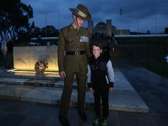 Sapper Curtis McGrath meets 8yr old Declan Sertori at the 2017 Anzac Day Dawn service at the Australian War Memorial in Canberra. Picture Kym Smith