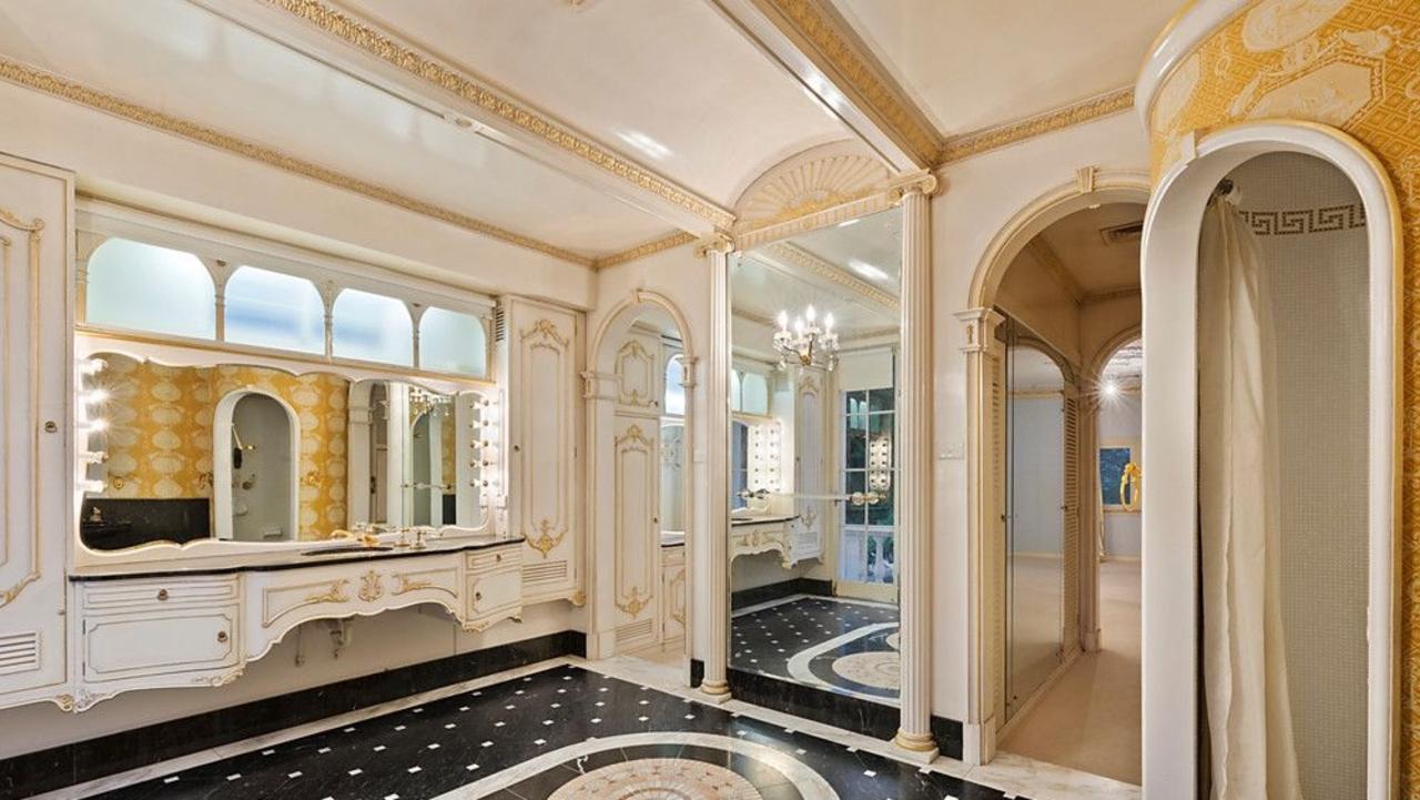 One of several marble bathrooms inside the mansion, originally styled with checkerboard flooring, pedestal basins and vintage fittings.