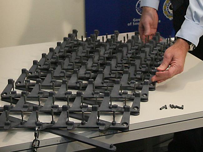 SA police Superintendent Graeme Adcock at Sturt Police Station showing off road spikes similar to those missing stolen after they were left behind by officer attending crime scene 13 Jun 2007. equipment