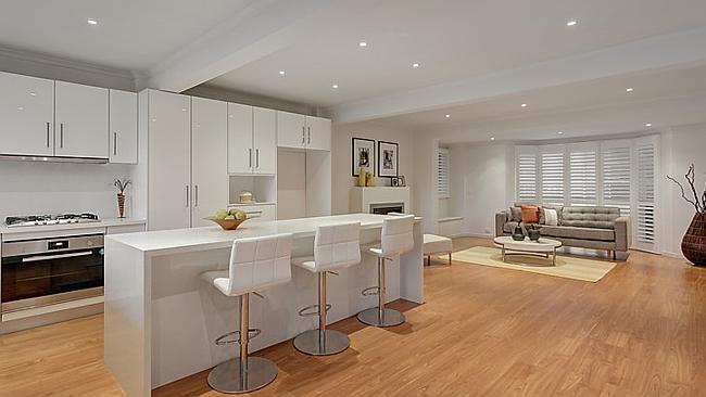 A crisp white kitchen services the family living zone, also with a gas fireplace.