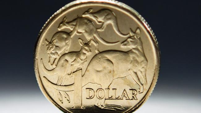 An Australian one-dollar coin is arranged for a photograph in Sydney, Australia, on Wednesday, April 17, 2013. Direct trading between the Australian dollar and yuan started on April 10. Photographer: Ian Waldie/Bloomberg