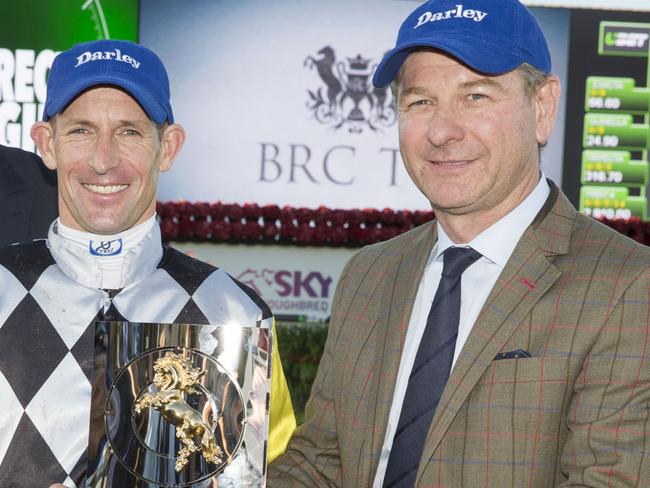 Jockey Hugh Bowman and trainer Kris Lees celebrate after winning the Kingsford Smith Cup. Picture: AAP