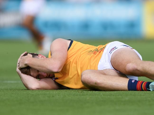 ADELAIDE, AUSTRALIA – FEBRUARY 23: Mark Keane of the Crows reacts to tackle by Willie Rioli of the Power and Sam Powell-Pepper of the Power causing a concussion during an AFL practice match between Port Adelaide Power and Adelaide Crows at Alberton Oval on February 23, 2024 in Adelaide, Australia. (Photo by Mark Brake/Getty Images)