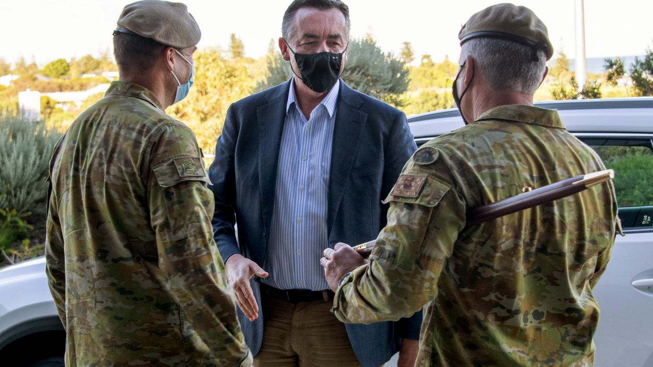 Veterans Minister Darren Chester is welcomed by Australian Army officer Lieutenant Colonel 'R' (left; protected identity), Commanding Officer of the Special Air Service Regiment, and Warrant Officer Class One 'S', Regimental Sergeant Major, as he arrives at Campbell Barracks, Perth this month. Picture: Department of Defence