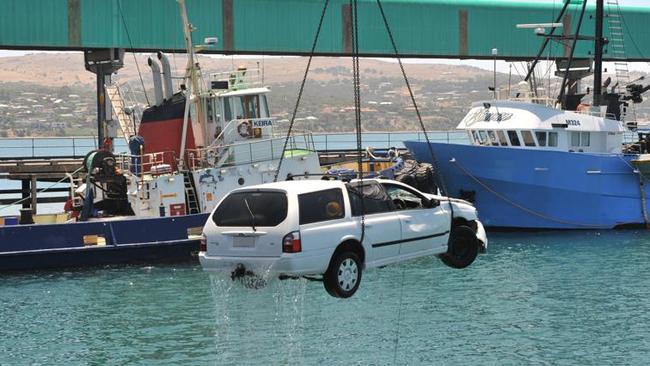 The Ford Falcon is lifted from the water at Port Lincoln. Picture: Ivon Perrin