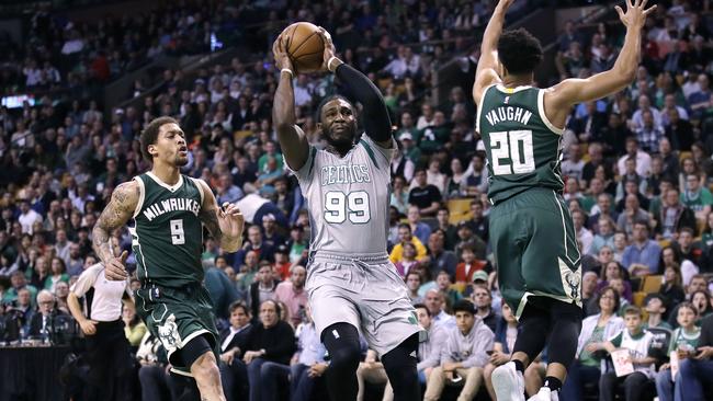 Boston Celtics forward Jae Crowder (99) drives between Milwaukee Bucks guard Rashad Vaughn (20) and forward Michael Beasley.