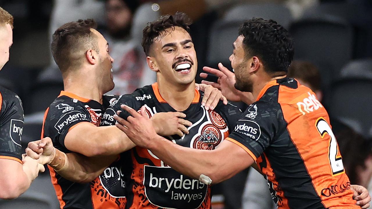 SYDNEY, AUSTRALIA - MAY 28: Daine Laurie of the Tigers celebrates with teammates after scoring a try during the round 12 NRL match between the Wests Tigers and the St George Illawarra Dragons at Bankwest Stadium on May 28, 2021, in Sydney, Australia. (Photo by Cameron Spencer/Getty Images)