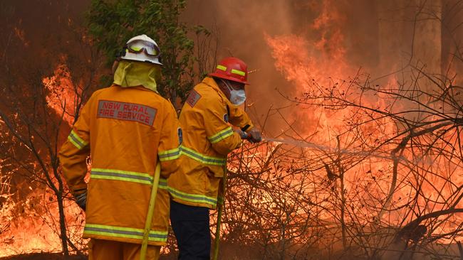 Firefighters tackling a blaze in Taree, 350km north of Sydney. Picture: Peter Parks, AFP.