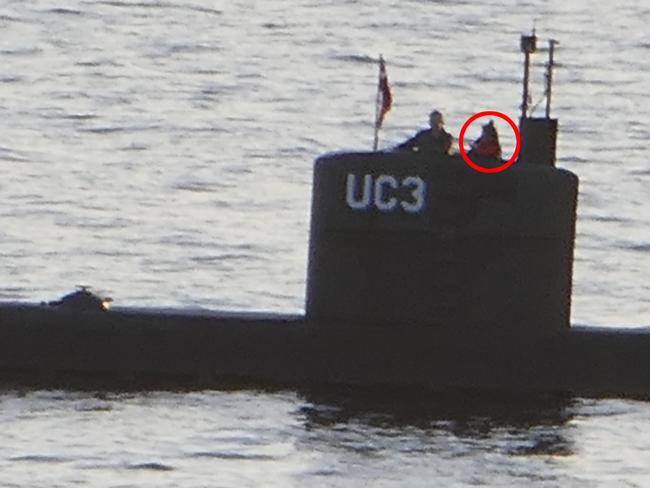 Swedish journalist Kim Wall (circled) stands in the submarine’s tower with owner Peter Madsen, who has been charged with her involuntary manslaughter. Picture: AFP / Peter Thompson