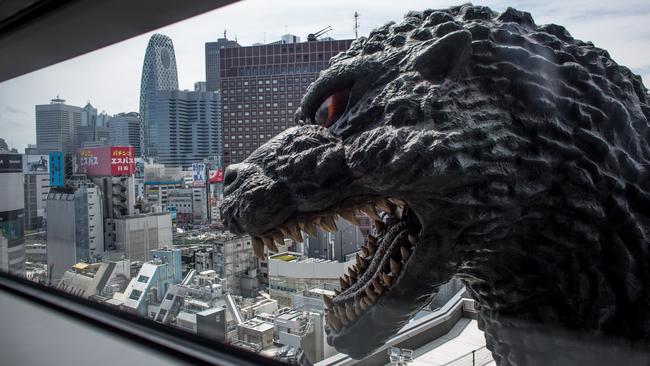 Famous character ... Godzilla, a fictional character which Toho created in 1954, can be seen in through a ninth floor hotel room window at the Hotel Gracery Shinjuku in Tokyo, Japan. Photo by Chris McGrath/Getty Images