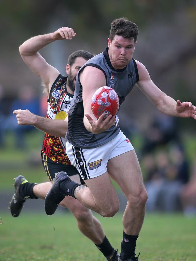 Port District’s Tom Corcoran gets away from his Goodwood opponent during the sides’ round three Adelaide Footy league division one clash. Picture: Dean Martin