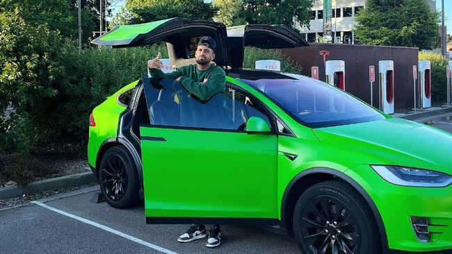 Nick Kyrgios with his Tesla, which was stolen last year. Picture: Instagram