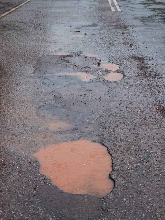 Potholes that opened in heavy rain caused major delays for commuters on Gardens Road. Picture: Pema Tamang Pakhrin