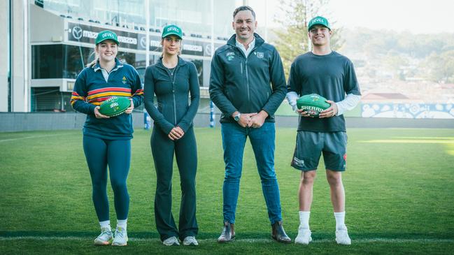 Business consumer manager Jesse O'Hara with three of the Tasmania Devils young members as it was announced the club will hit 210,000 members this week. Picture: AFL Tasmania
