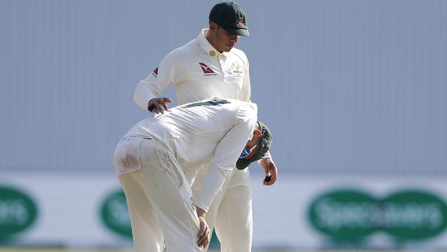 Nathan Lyon is consoled by Usman Khawaja after Australia lost the third Test. Picture: Getty Images