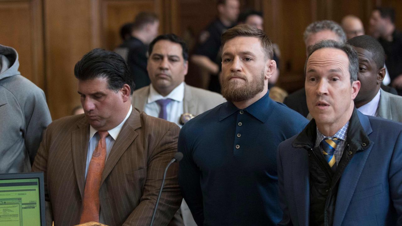 Irish Mixed Martial Arts fighter Conor McGregor (2R) looks on next to his lawyer Jim Walden (R) and John Arlia (2L) during his arraignment at the Brooklyn Court on April 6, 2018 in New York. McGregor was charged with assault and criminal mischief by New York police on April 6, 2018 and was due to appear in court. The 29-year-old superstar reportedly surrendered at a Brooklyn police station late Thursday after allegedly attacking a shuttle bus loaded with fellow mixed martial arts fighters attending a New York media event at the Barclays Center stadium.Video footage showed McGregor hurling a dolly through a side window of the bus as it moved slowly in a parking lot at the stadium in Brooklyn.  / AFP PHOTO / POOL / Mary Altaffer