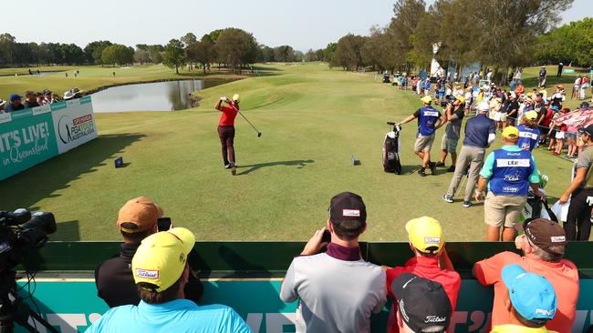 Adam Scott tees off as the crowd watches on. Picture: Chris Hyde/Getty Images