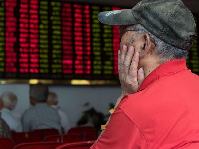 This photo taken on August 13, 2015 shows investors monitoring screens showing stock market movements at a brokerage house in Shanghai. Shanghai stocks were down 0.40 percent, or 15.01 points to 3,779.10, by the break on August 20, 2015, narrowing morning losses on expectations of more government support measures for equities following volatile trading the previous day, dealers said. AFP PHOTO / JOHANNES EISELE