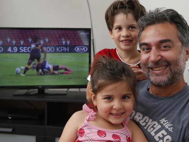 Basak Yagci, watching Australian Rugby League with his son Kaya, 6, and his daughter Lara, 5, in London. Picture: Hollie Adams