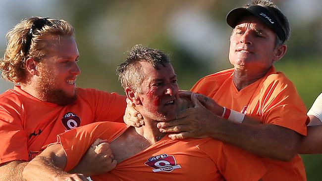 Port Douglas trainer Glenn Dickson has blood spilling from his face after an altercation with Trinity Bulldogs player Brian Durbidge during the Port Douglas and Centrals Trinity Beach Bulldogs AFL Cairns preliminary final at Cazalys. PICTURE: JUSTIN BRIERTY.