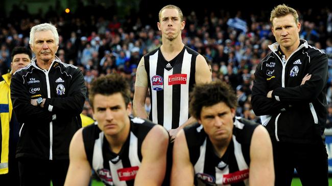 Mick Malthouse, left, with Darren Jolly, Nick Maxwell, Leigh Brown and Nathan Buckley after the 2011 grand final.