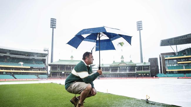 7/2/20: SCG Curator, Adam Lewis looks out at a wet SCG which is supposed to host the Big Bash but will be washed out. John Feder/The Australian