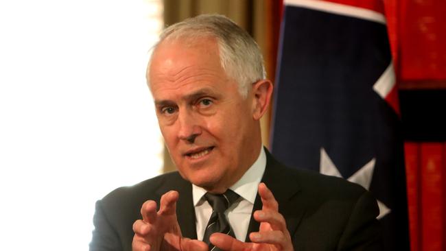 Time for a spell? “Look into the eyes, not around the eyes, into the eyes,” the PM seems to be saying.  Picture: Stuart McEvoy.