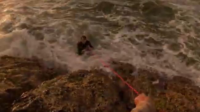 Sam finally grabs a thin red rope he has for use with a crab pot, which he and Aiden untangle before throwing it out to the tiring teen who has told them he is too exhausted to swim closer. Pictures: Aiden Whiteman, Whiteey's FIshing.