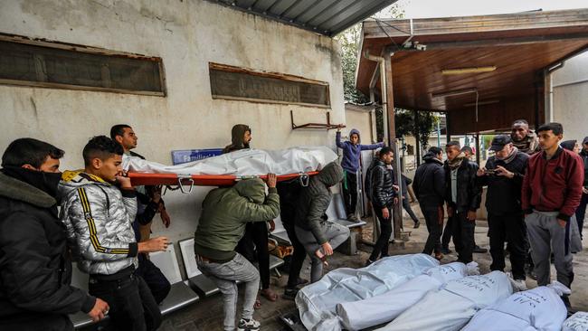 People mourn as they collect the bodies of friends and relatives killed in an Israeli air strike. Picture: Getty Images