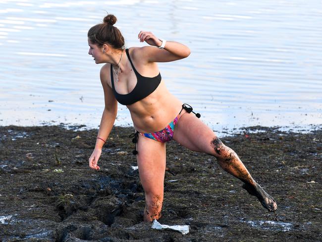 18 year old Emmie Frederico demonstrating how difficult the black sludge makes it to maneouver around the waters edge due to the black sludge. There's a campaign to get the the black sludge at Sandringham Beach cleaned up. PICTURE : PENNY STEPHENS. 13TH JULY 2018