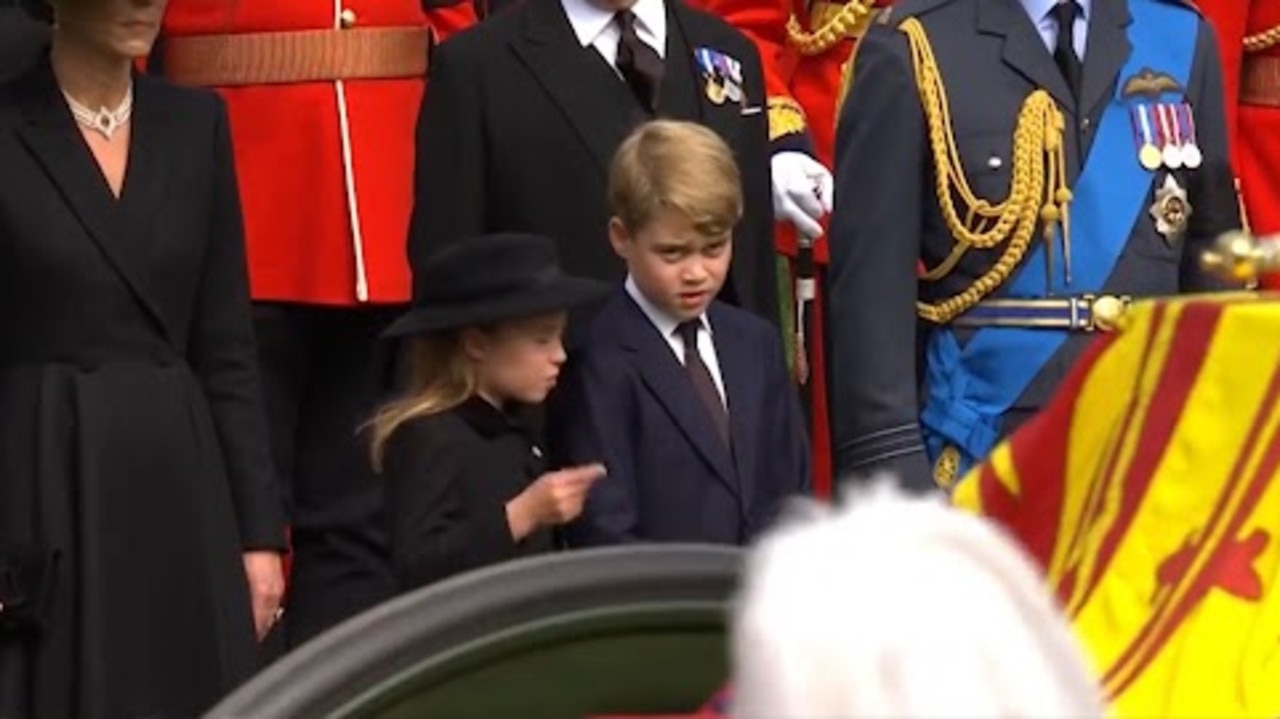 Princess Charlotte reminds Prince George – the future king – of royal protocol at the Queen’s funeral.