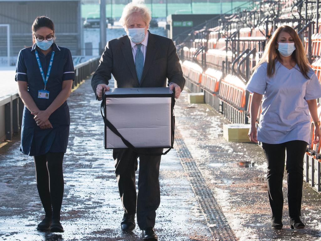 British Prime Minister Boris Johnson carries doses of the Oxford/AstraZeneca coronavirus vaccine for distribution at Barnet Football Club in north London. Picture: Getty Images