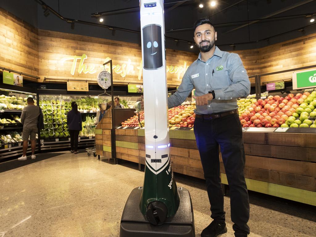 A staff member poses with the hazard spotting robot in the new Gregory Hills store.