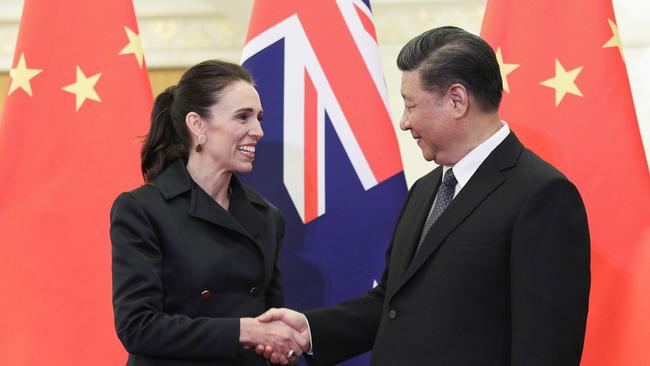 Hand of friendship: Jacinda Ardern demonstrates the correct way to deal with China, with a big grin for Xi Jinping. Picture: AFP