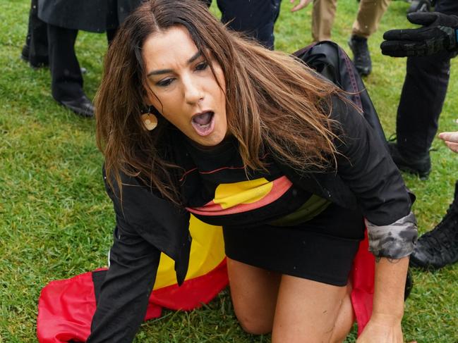 ONE TIME WEB USE FOR NEWS.COM.AU - FEES APPLY -  Independent Senator Lidia Thorpe crawls away after attempting to disrupt British anti-transgender rights activist Kellie-Jay Keen-Minshull, also known as Posie Parker at a Ã¢â¬ÅLet Womaen SpeakÃ¢â¬Â anti trans rally outside Parliament House in Canberra, Thursday, March 23, 2023. (AAP Image/Michelle Haywood) NO ARCHIVING