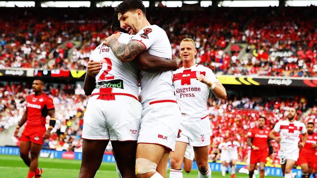 Jermaine McGillvary celebrates a try with England teammate Gareth Widdop.