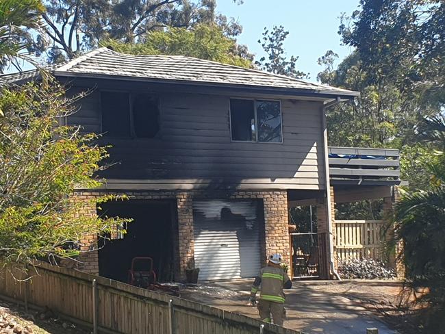 Fire crews from Beenleigh and Loganlea clean up following a house fire on Curve Avenue in Loganholme on Saturday morning. Picture: Jodie Munro O'Brien