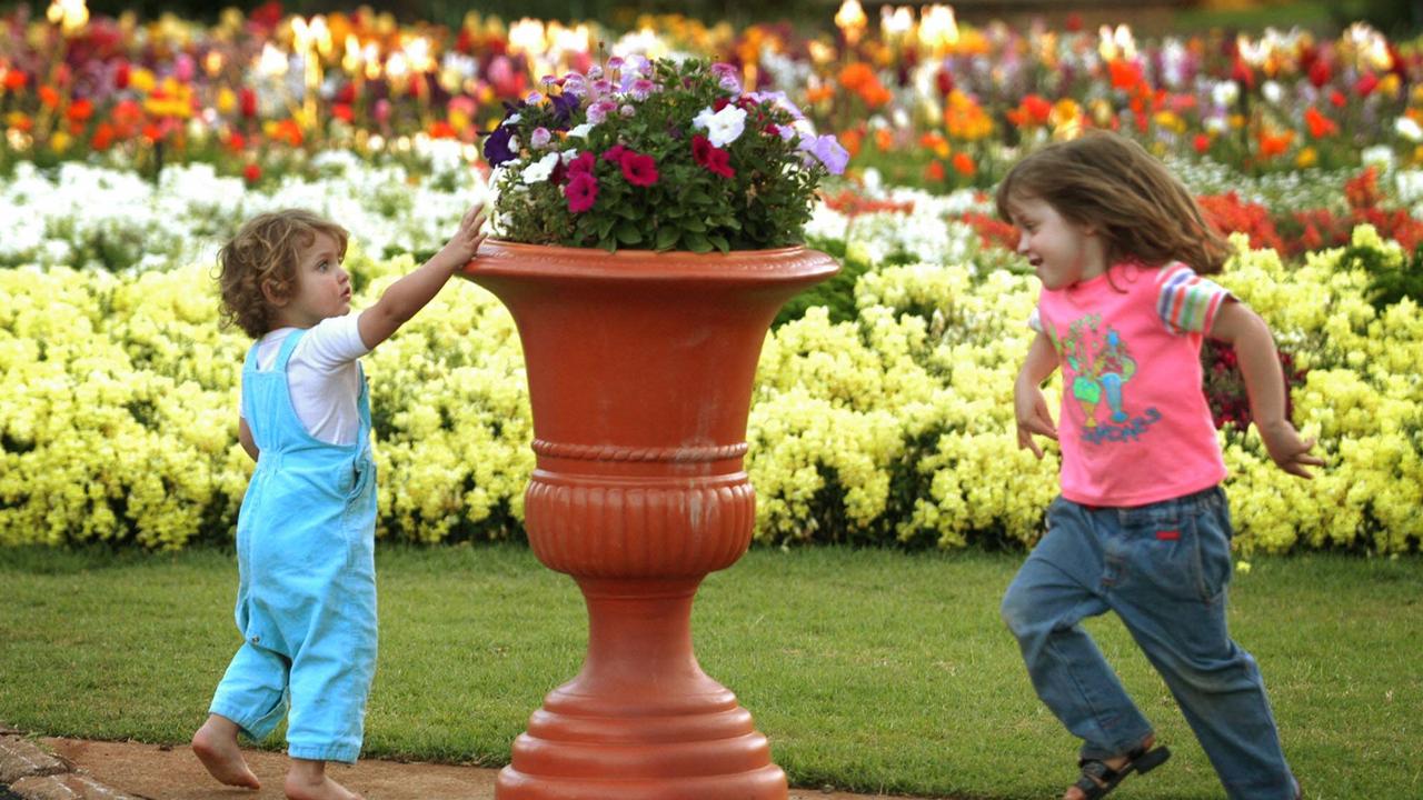 Carnival of Flowers time – local children Courtney, 2, with her sister Stefanie, 4, playing in Queens Park Toowoomba. Picture: David Martinelli